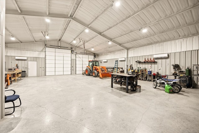 garage with an AC wall unit and a workshop area