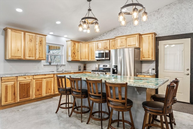 kitchen featuring pendant lighting, light stone countertops, lofted ceiling, and stainless steel appliances