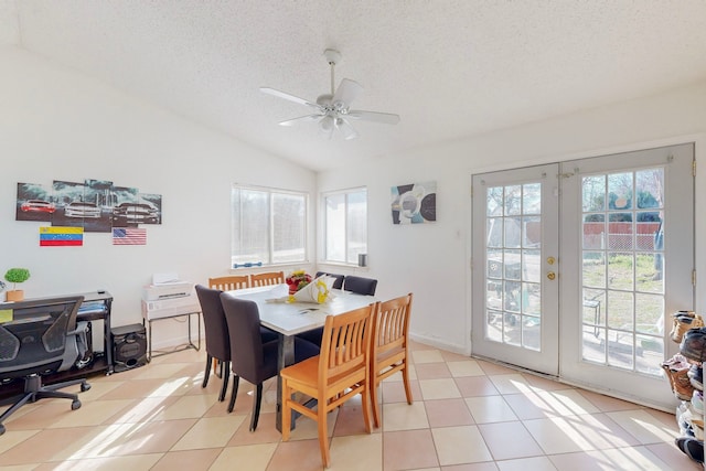 tiled dining area featuring vaulted ceiling, ceiling fan, french doors, and a textured ceiling