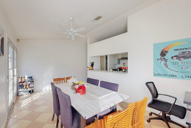 tiled dining room featuring ceiling fan and lofted ceiling