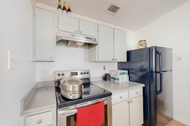 kitchen featuring white cabinets, black fridge, stainless steel electric range oven, and a textured ceiling