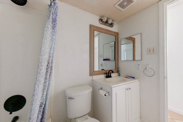 bathroom with vanity, a textured ceiling, toilet, and curtained shower