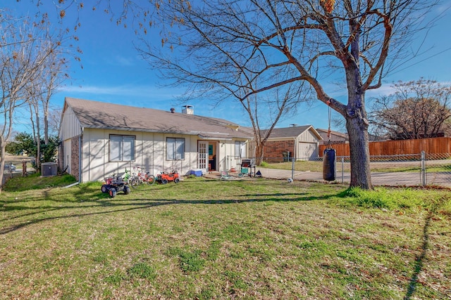 back of house with a yard and central AC unit