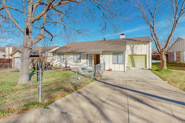 ranch-style house featuring a front yard and a garage