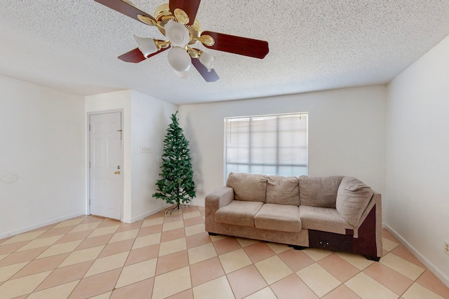 tiled living room with ceiling fan and a textured ceiling