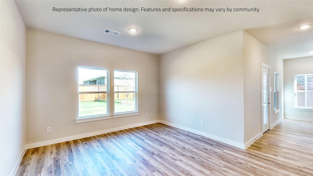 spare room featuring light wood-type flooring