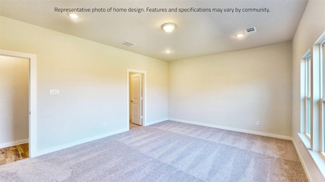 unfurnished room with light colored carpet