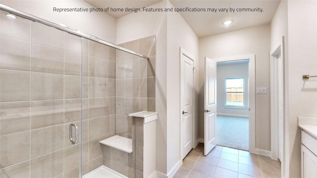 bathroom with tile patterned flooring, vanity, and a shower with door