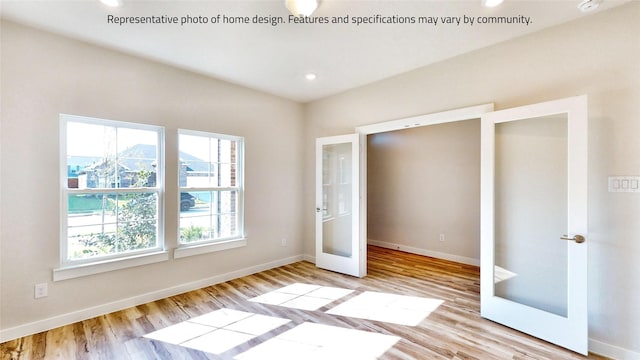 unfurnished bedroom with french doors and light wood-type flooring