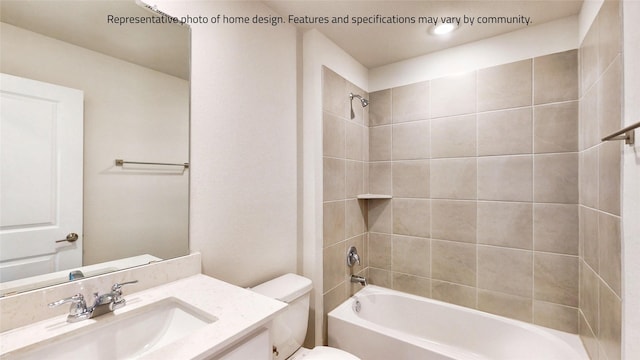 full bathroom featuring tiled shower / bath combo, toilet, and vanity