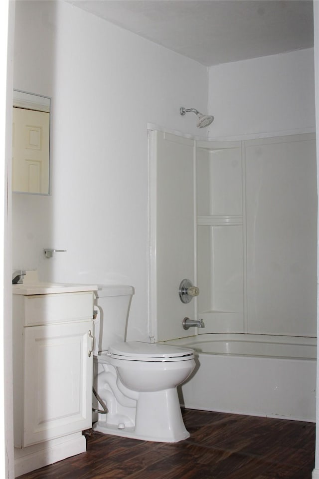 full bathroom with hardwood / wood-style floors, vanity, shower / bathtub combination, and toilet