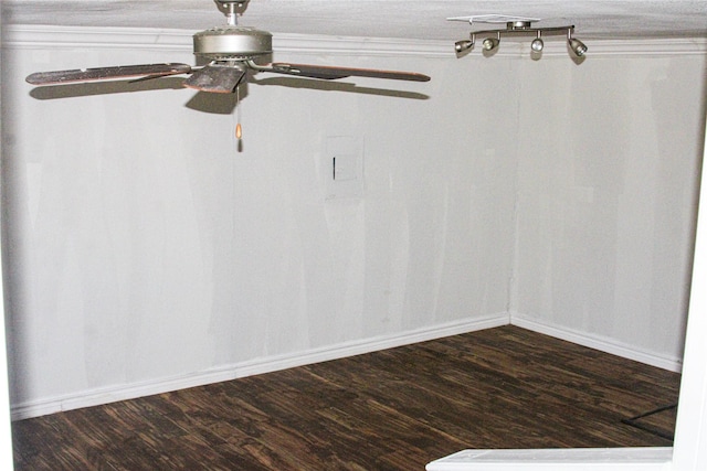 empty room featuring crown molding and dark wood-type flooring