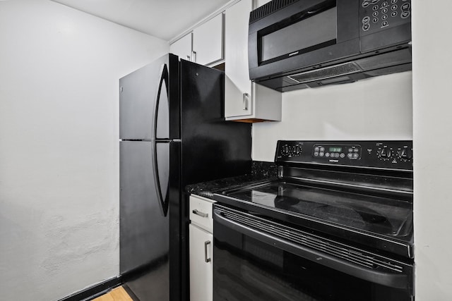 kitchen with white cabinetry and black appliances