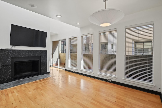 unfurnished living room with a fireplace and hardwood / wood-style flooring