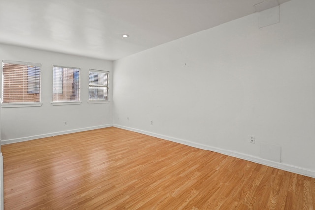 empty room with light hardwood / wood-style flooring