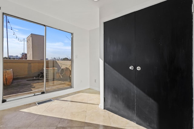 doorway featuring light tile patterned flooring