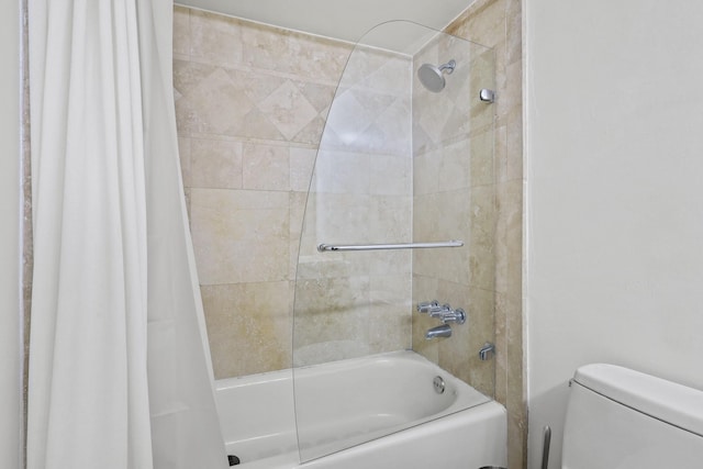 bathroom with toilet and shower / bath combo with shower curtain