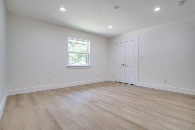 unfurnished room with light hardwood / wood-style flooring