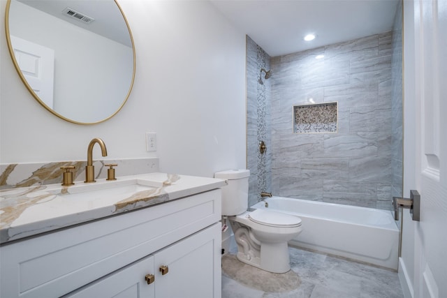 full bathroom featuring vanity, toilet, and tiled shower / bath combo