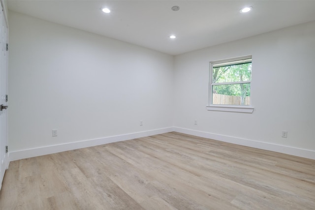 unfurnished room with light hardwood / wood-style floors