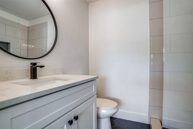 bathroom with tile patterned floors, vanity, and toilet