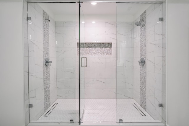 bathroom with a shower with shower door