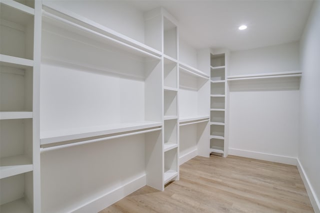 walk in closet with hardwood / wood-style floors