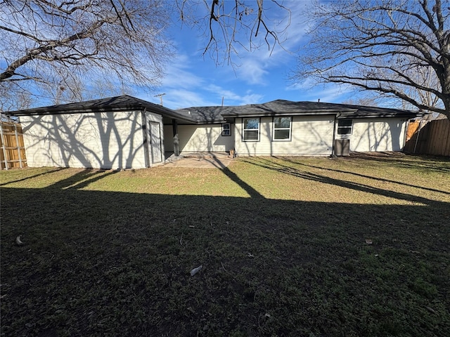 back of property with a garage and a yard