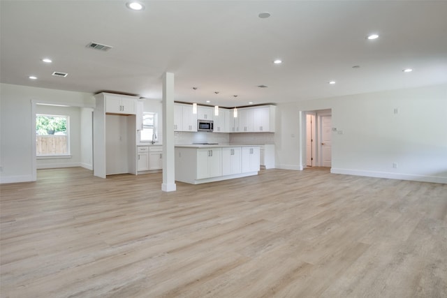 unfurnished living room featuring light hardwood / wood-style flooring