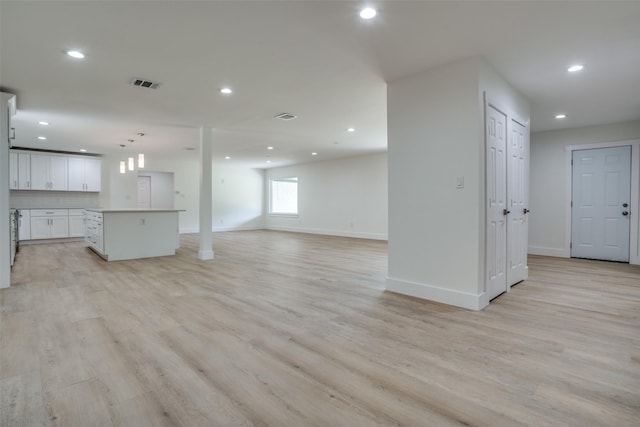 unfurnished living room with light hardwood / wood-style flooring