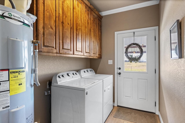 washroom with washing machine and clothes dryer, cabinets, water heater, light hardwood / wood-style floors, and ornamental molding