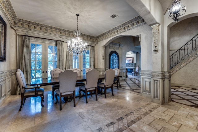 dining area featuring an inviting chandelier and french doors