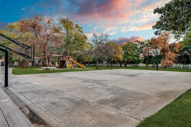 view of sport court featuring a yard and a playground