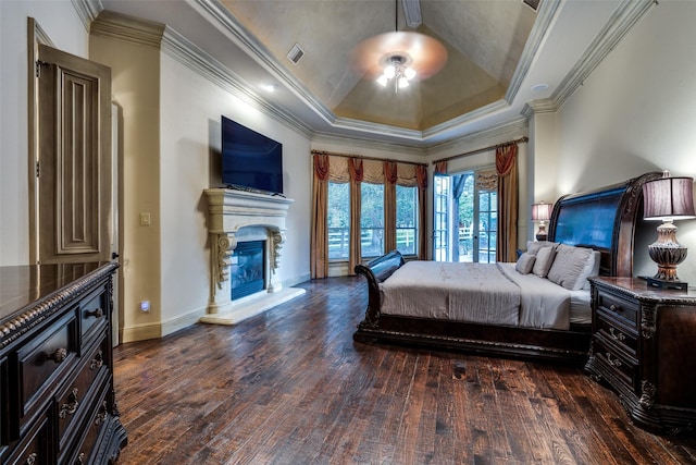 bedroom with a raised ceiling, ornamental molding, ceiling fan, and dark hardwood / wood-style flooring