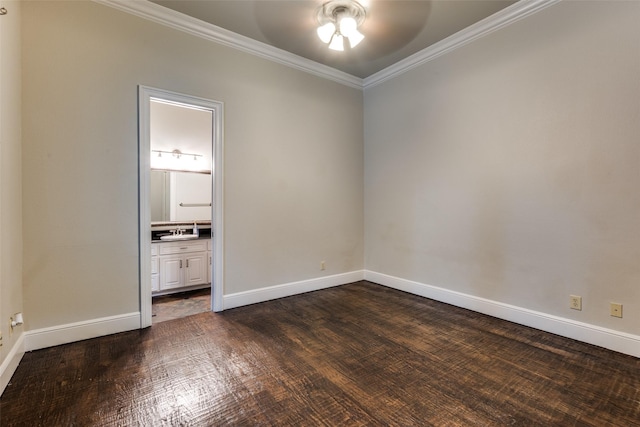 unfurnished bedroom with sink, ornamental molding, dark hardwood / wood-style floors, and ensuite bathroom