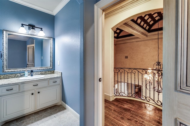 bathroom featuring vanity, tile patterned flooring, ornamental molding, and a chandelier