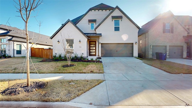 view of front of property with a garage and a front lawn