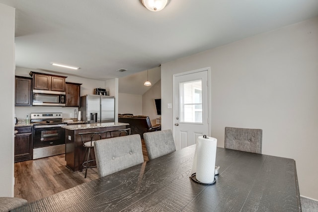 dining space with dark wood-type flooring