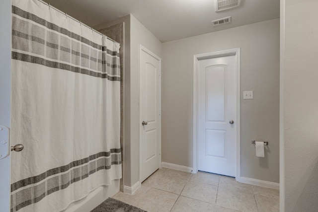 bathroom featuring tile patterned floors and shower / bathtub combination with curtain