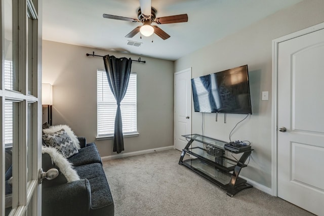 living room featuring light colored carpet and ceiling fan