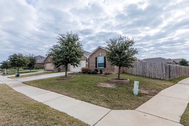 view of front of house with a garage and a front yard