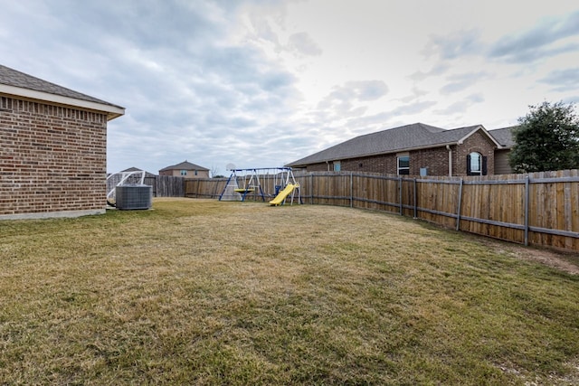 view of yard featuring a playground and central air condition unit