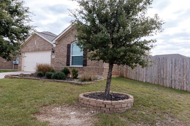 view of front of house featuring a garage and a front lawn