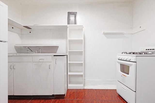 kitchen with white cabinets, white appliances, sink, and dark wood-type flooring