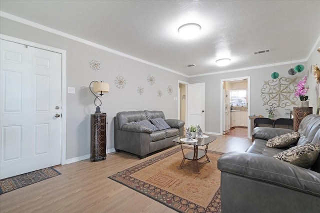 living room with wood-type flooring and ornamental molding