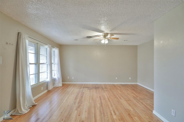 spare room featuring ceiling fan, light hardwood / wood-style floors, and a textured ceiling