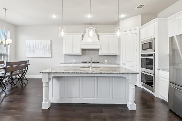 kitchen with pendant lighting, white cabinetry, and stainless steel appliances