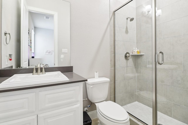 bathroom with vanity, toilet, and walk in shower