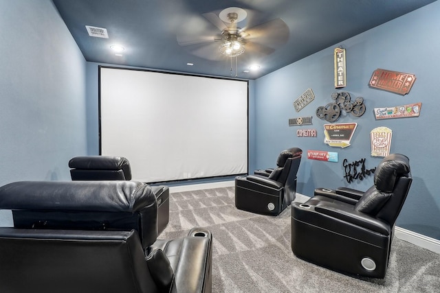 cinema room with ceiling fan and carpet floors