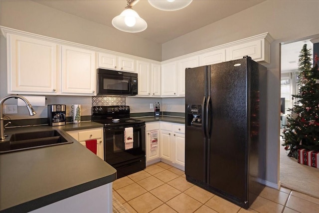 kitchen with light tile patterned flooring, sink, black appliances, hanging light fixtures, and white cabinets